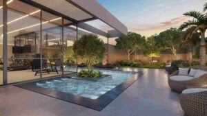 Piscina infantil com área de descanso e solarium ao redor e praça de contemplação com bastante verde do lado.